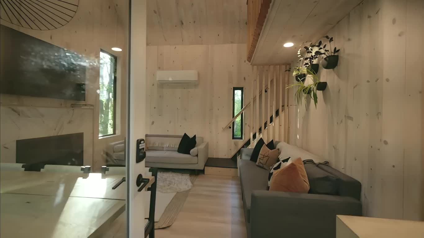 A walk in through the door of the amenity house, past the sofa to the fireplace